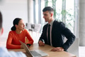 A young, diverse business team sitting together in a modern office, exchanging ideas and business - PhotoDune Item for Sale