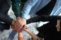 A top view of business people joining hands in a circle, symbolizing unity, collaboration, and - PhotoDune Item for Sale