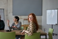 A young, diverse business team sitting together in a modern office, exchanging ideas and business - PhotoDune Item for Sale