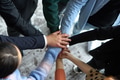 A top view of business people joining hands in a circle, symbolizing unity, collaboration, and - PhotoDune Item for Sale