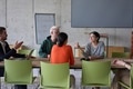 A young, diverse business team sitting together in a modern office, exchanging ideas and business - PhotoDune Item for Sale