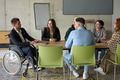 A diverse group of business professionals sitting in an office meeting with their director, who is - PhotoDune Item for Sale