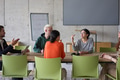 A young, diverse business team sitting together in a modern office, exchanging ideas and business - PhotoDune Item for Sale
