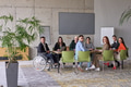 A diverse group of business professionals sitting in an office meeting with their director, who is - PhotoDune Item for Sale