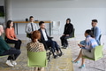 Corporate business team meeting with a manager or coach. Group of happy diverse, multiracial people - PhotoDune Item for Sale