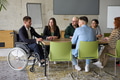 A diverse group of business professionals sitting in an office meeting with their director, who is - PhotoDune Item for Sale