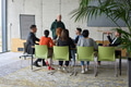 A young, diverse business team sitting together in a modern office, exchanging ideas and business - PhotoDune Item for Sale