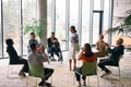 Corporate business team meeting with a manager or coach. Group of happy diverse, multiracial people - PhotoDune Item for Sale