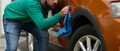 A man meticulously washes and cleans his car in the driveway of his home, showcasing pride in his - PhotoDune Item for Sale