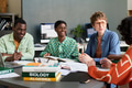 Collaborating in Modern Classroom With Books and Laptops - PhotoDune Item for Sale