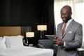 Hotel Manager using Digital Tablet in Hotel Room - PhotoDune Item for Sale
