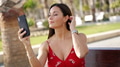 Woman in Red Dress Taking Selfie in Sunny Park - PhotoDune Item for Sale