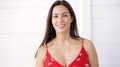 Confident Woman Smiling in a Red Floral Dress Outdoors - PhotoDune Item for Sale