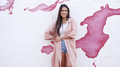 Stylish Woman Standing Against a Pink Paint Splash Wall - PhotoDune Item for Sale