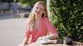 Smiling Woman Enjoying Coffee Outdoors on a Sunny Day - PhotoDune Item for Sale