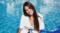 Elegant Woman Relaxing by Sunny Poolside in Spain - PhotoDune Item for Sale