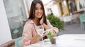 Happy Woman Enjoying a Drink at an Outdoor Cafe - PhotoDune Item for Sale