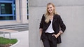Confident Businesswoman Leaning Against Concrete Wall - PhotoDune Item for Sale