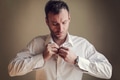 Man fastening his shirt - PhotoDune Item for Sale