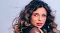 Beautiful model with drawn hearts on her cheeks posing in the studio. - PhotoDune Item for Sale