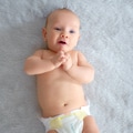 Cute baby with blue eyes. Happy newborn boy lies on a blue blanket - PhotoDune Item for Sale