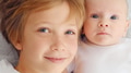 Smiling faces of the brothers, top view. Happy newborn baby with his brother. - PhotoDune Item for Sale
