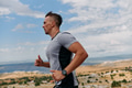 Determined Athlete Running Through Rugged Mountain Terrain at Sunrise. - PhotoDune Item for Sale