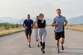 A group of friends maintains a healthy lifestyle by running outdoors on a sunny day, bonding over - PhotoDune Item for Sale