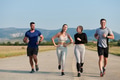 A group of friends maintains a healthy lifestyle by running outdoors on a sunny day, bonding over - PhotoDune Item for Sale